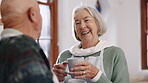 Elderly couple, laughter or coffee in conversation in kitchen, love or joke in retirement. Senior man, woman or marriage in espresso in morning comedy, silly together in wellness, talking or home 