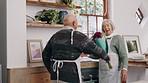 Senior couple, birthday or surprise flowers in house to love, care or thank you in marriage. Happy elderly man, woman or celebration gift of floral bouquet in hug or kiss, anniversary or family home 