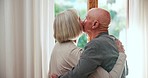 Home, kiss or old couple hug with support, love or care in marriage, retirement or morning by window. Back, romantic mature man or senior woman bonding together on holiday vacation break to relax