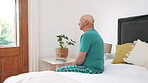 Lonely, senior man and thinking in bedroom, home or depressed in retirement with grief in the morning. Sad, memory or tired elderly person in house worried, thoughtful and mental health in isolation