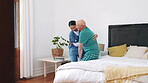 Nurse, walking and helping senior man from bed in retirement, nursing home and healthcare. Caregiver, support or woman with elderly person in bedroom with care for sick patient with mobility in house