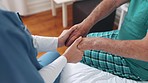 Nurse, holding hands and support patient on bed, trust or medical help, empathy or kindness. Closeup, caregiver comfort senior person in bedroom and cancer, healthcare rehabilitation or hope in home