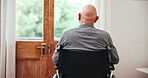 Back, wheelchair and view with an elderly man by a glass door in his retirement home for thinking or nostalgia. Morning, memory and a senior person with a disability in the bedroom of an apartment