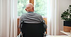 Back, wheelchair and view with a senior man by a glass door in his retirement home for thinking or nostalgia. Morning, memory and an elderly person with a disability in the bedroom of an apartment