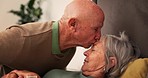 Bed, sick and senior couple kiss forehead for support, bonding and compassion together at home. Retirement, marriage and elderly man and woman embrace in bedroom for illness, healing and recovery