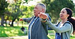 Nurse, stretching and outdoor with senior man and caregiver with exercise and wellness in a park. Support, physical therapy and healthcare professional with physio, relax and retirement with care