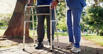 Senior, man and walker with nurse for walking, support and mobility outdoor in park or nature with wellness. Elderly, person or caregiver for physiotherapy, healing and disabled with helping and care