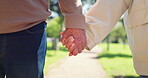 Love, couple holding hands at park and care, trust and together in garden outdoor. Closeup, support and man and woman in nature for healthy relationship, connection and loyalty in marriage commitment