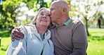 Senior, couple and kiss or talking in park with hugging, conversation and bonding for retirement. Elderly, man or woman outdoor in nature with communication, love and discussion for relax or date