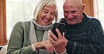 Phone, laughing and senior couple on a sofa networking on social media, mobile app or the internet. Happy, conversation and elderly woman and man in retirement scroll on cellphone together at home.