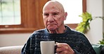 Thinking, coffee and senior man relax on a sofa peaceful, calm and enjoying a quiet morning in his home. Face, break and elderly male person with tea in a living room resting or enjoying retirement