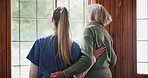 Window, caregiver and senior woman in nursing home for support, care and assisted living. Healthcare, thinking and nurse with elderly person embrace for empathy, helping and wellness in retirement