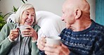 Happy, love and senior couple with coffee in a living room relax, bond and laughing in their home together. Tea, break and old people with funny, joke or conversation in a house enjoying retirement