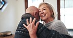 Senior couple in living room, dancing and love in retirement, marriage commitment and fun together. Music, old man and happy elderly woman in celebration with smile, romance and energy in apartment.