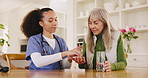 Healthcare, medicine or planning with a nurse and old woman in an assisted living retirement home. Medical, pills or chronic treatment with a caregiver and senior patient at a dining room table