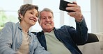 Happy senior couple, selfie and sofa with kiss, care and bonding in retirement with post on web blog. Elderly man, woman and photography for memory, profile picture or hug for romance on social media