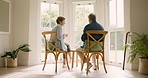 Old couple in home, tea and discussion in morning with love, support and conversation. Relax, senior man and woman at table, drinking and bonding, marriage in retirement and communication with trust.