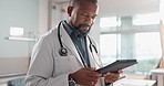 Healthcare, typing and a black man or doctor with a tablet for a medical app or communication. Mature, reading email and an African surgeon with technology for results, information or surgery advice