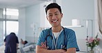 Healthcare, doctor and asian man with arms crossed at hospital with smile for support, service and wellness. Medicine, professional and expert with happiness and pride for career, surgery or care