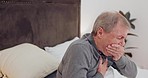 Senior man coughing in bed for sickness, chest infection or flu in his modern retirement home. Medical, recovery and elderly male patient resting with cold or sickness in his bedroom in house.