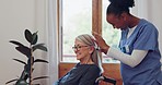 Elderly woman, retirement home and caregiver with brush hair, happy and care for disabled person. Diversity, nurse and patient in wheelchair with communication, grooming and kindness in healthcare