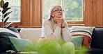 Thinking, reflection and senior woman on sofa in the living room with memory or dreaming face. Relax, idea and elderly female person in retirement with alzheimers disease in the lounge of modern home