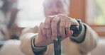 Walking stick, hands and senior man with a disability in home, apartment or retirement with support for injury. Elderly, closeup or person with wood cane to help balance or mobility with arthritis