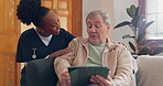 Healthcare, tablet and an elderly man with a caregiver during a home visit for medical checkup in retirement. Technology, medicine and appointment with a nurse talking to a senior patient on the sofa