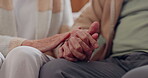 Holding hands, empathy and an elderly couple closeup in their home for love, support or trust in retirement. Hope, healing or sympathy with senior people on a sofa in the living room of their home