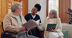 Elderly care, nurse and talking in home with people reading books, news or tablet with discussion of support. Retirement, caregiver and relax in conversation or house living room with notebook