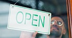 Open sign, front door and happy restaurant man, small business owner or boss start work day of commerce service industry. Morning signage, manager billboard and barista at coffee shop opening time 