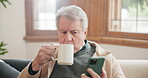 Coffee, phone and senior man on sofa, streaming video or show in living room at home. Drink tea, smartphone and serious person on couch for social media, reading email notification or news on web app