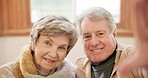 Selfie, love and retirement with a senior couple laughing on a sofa in the living room of their home together. Portrait, smile or happy with an elderly man and woman having fun in their apartment