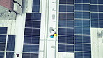 Overhead, solar energy and an engineering team on the roof of a building to install panel technology. Engineer, construction and renewable power with people working on a sustainability project