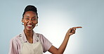 Face, waitress or pointing in studio to mockup space in apron with smile, offer or cafe choice. Blue background, startup promotion or happy black woman advertising business, discount or special deal