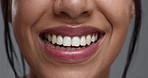Woman, mouth and closeup in studio for dental wellness, beauty and change with cosmetics by background. Girl, teeth whitening and smile for cleaning, health and zoom for oral care with hygiene