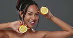 Face, skincare and happy woman with lemon in studio isolated on gray background. Portrait, natural fruits and food of model for cosmetic, healthy diet and nutrition for wellness, vitamin c and beauty
