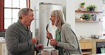 Happy, senior couple and cooking singing in the kitchen together for playful bonding. Smile, fun and elderly man and woman with love, dance and music while preparation for dinner, lunch or breakfast