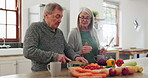 Kitchen, senior couple and cooking vegetables, food or prepare recipe, organic nutrition or brunch ingredients. Talking, home and marriage people, old man or elderly woman giving cutting instruction