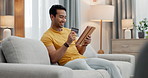 Credit card, tablet and man doing online purchase from couch in a home as ecommerce with internet to relax. Happy, website and person buying on the web or banking on app on living room sofa to pay