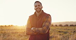 Farmer, face and man with arms crossed in field for agriculture, sustainability and sunshine with smile. Farm, person or countryside with confidence for land, production and entrepreneur on grass