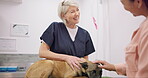 Vet, dog and talking happy people, mature animal doctor or nurse consulting on medical support, clinic care or wellness. Veterinary, conversation and women helping client, healing pet or healthcare