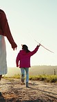 Flying airplane, running and family with a toy in nature for playing, freedom and holding hands. Back, together and a mother and child with toys for travel and walking in the countryside in summer