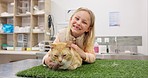 Vet, face of happy girl child with cat in consultation room for checkup, examination or treatment. Veterinary, pet care and portrait of kid with animal at a clinic for medical assessment or routine