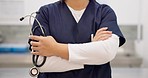 Woman, hands and stethoscope of professional doctor with arms crossed in healthcare or medical service at hospital. Closeup of female person or nurse in confidence with tools or equipment for health