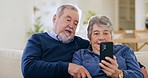 Phone, funny and senior couple on sofa in home, streaming comedy video or meme on lens flare. Smartphone, laughing and happy man and woman in living room reading email, social media and online news