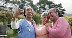 Friends, women and crazy selfie in garden with happy, retirement village and outdoor laughter in sun. Nurse, diversity and old people with smartphone for memory, nature and social media with comedy