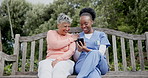 Senior, woman and caregiver with phone in nature with communication, laughing and joke in garden. Elderly, black people and nurse with smartphone on swing with humour, conversation and happiness