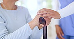 Nurse, holding hands and support woman with cane, empathy and trust in retirement home. Comfort, closeup of caregiver and senior person with a disability, walking stick and help, kindness and health