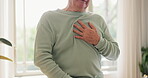 Hands, heart attack and man with emergency in home, massage chest and cardiovascular problems. Pain, senior person and family history of blood disease, anxiety and living room with cardiac arrest